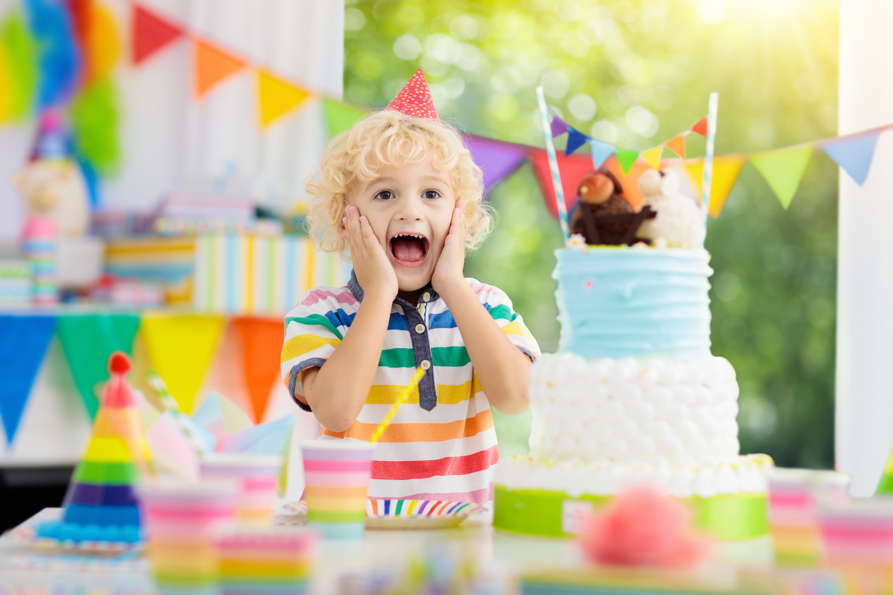 Kids birthday party. Child blowing out cake candle